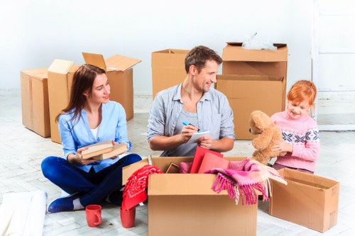Packed boxes and removals team preparing for a local move in Feltham