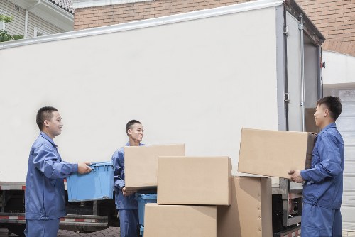 Professional movers handling furniture during a house move in Feltham