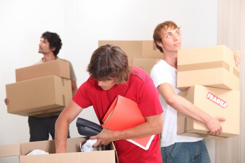 Local movers handling furniture near a flat in Feltham